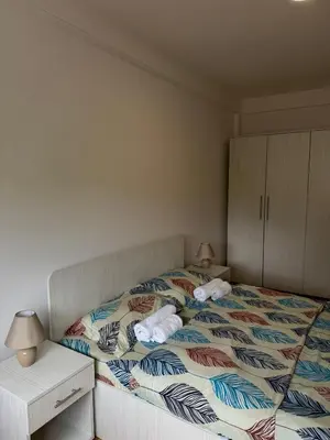 a bedroom with a bed with towels on it at Olimp apartmani Sokobanja in Soko Banja