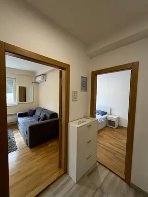 a living room with a couch and a mirror at Olimp apartmani Sokobanja in Soko Banja