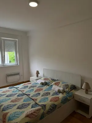 a bedroom with a bed and a window at Olimp apartmani Sokobanja in Soko Banja