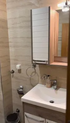 a bathroom with a sink and a mirror at Olimp apartmani Sokobanja in Soko Banja