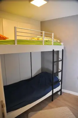 a bunk bed in a small room with a bunk bed underneath it at Apartman Family Konaci in Kopaonik