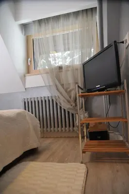 a living room with a tv and a window at Apartman Family Konaci in Kopaonik