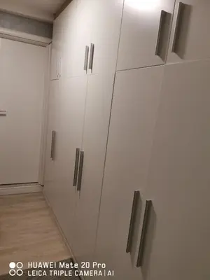 a room with white cabinets with silver handles at Apartman Family Konaci in Kopaonik