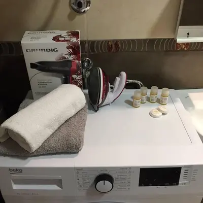 a counter top with a hair dryer and a box and cups at Park app in Vrnjačka Banja