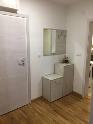 a white room with a door and a mirror at Park app in Vrnjačka Banja
