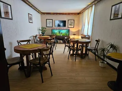 a restaurant with tables and chairs and a fish tank at ApartHotel Kopaonik in Brzeće
