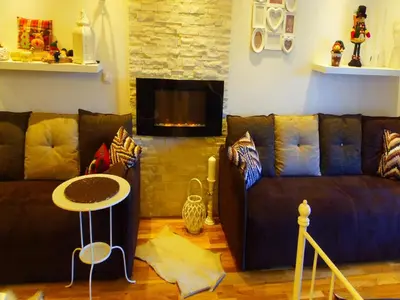 a living room with a couch and a table at Visnja Apartment in Kopaonik