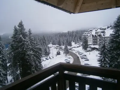 a view from the balcony of a resort in the snow at Visnja Apartment in Kopaonik