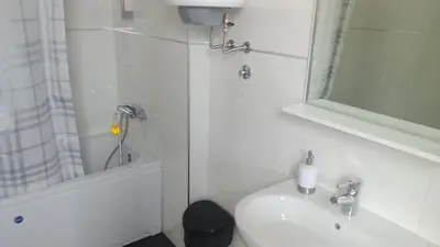 a bathroom with a toilet and a sink and a shower at Vrnjci House in Vrnjačka Banja