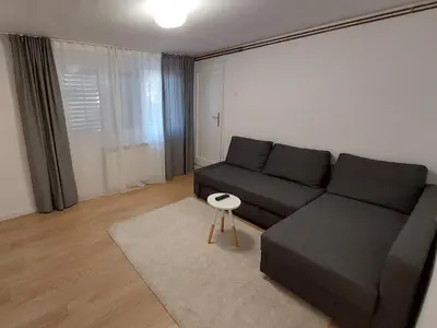 a living room with a black couch and a table at Vrnjci House in Vrnjačka Banja