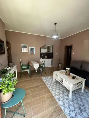 a living room with a couch and a table at San apartman in Vrnjci