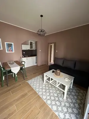 a living room with a couch and a table at San apartman in Vrnjci