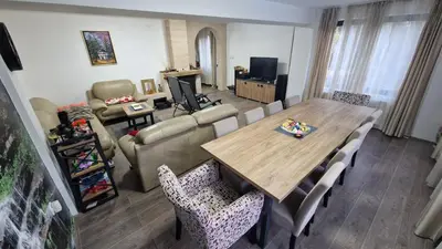 a living room with a large wooden table and chairs at Villa Anja in Pirot