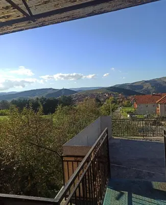 a balcony with a view of the mountains at Kuća na dan in Supnje