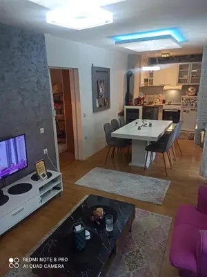 a living room with a table and a tv at Kuća na dan in Supnje