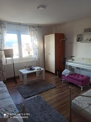a living room with a piano and a table at Kuća na dan in Supnje