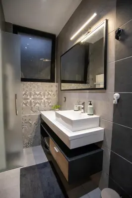 a bathroom with a white sink and a mirror at Style and Shine Sunrise Apartment in Niš