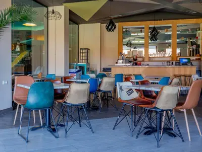 a group of chairs and tables in a restaurant at Apartman Kopaonik u Kraljevim Čardacima in Kopaonik