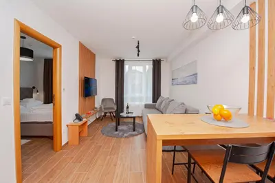 a living room with a table and a couch at Apartman Kopaonik u Kraljevim Čardacima in Kopaonik