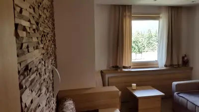 a living room with a couch and a window at Apartmani Kopaonik Centar Maglic in Kopaonik