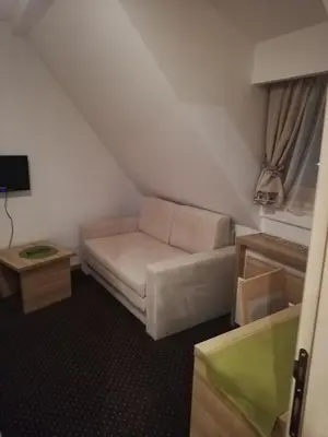 a small living room with a couch and a table at Apartmani Kopaonik Centar Maglic in Kopaonik