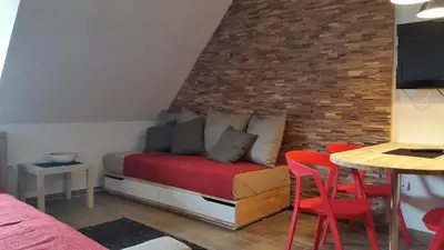 a bedroom with a bed and a table and chairs at Apartmani Kopaonik Centar Maglic in Kopaonik