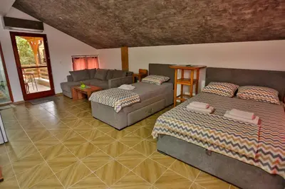 a living room with two beds and a couch at Smeštaj Đorić in Leskovac