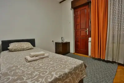 a bedroom with a bed with two towels on it at Smeštaj Đorić in Leskovac