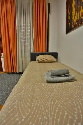 a bed with two towels on it in a bedroom at Smeštaj Đorić in Leskovac