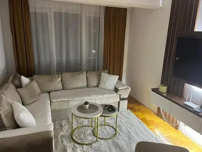 a living room with a couch and a table at Saric LuxApartman in Kruševac