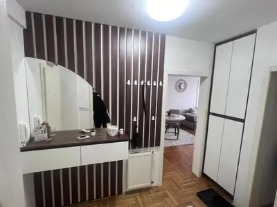 a bathroom with a sink and a mirror on a wall at Saric LuxApartman in Kruševac