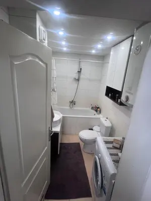 a bathroom with a toilet and a tub and a sink at Saric LuxApartman in Kruševac