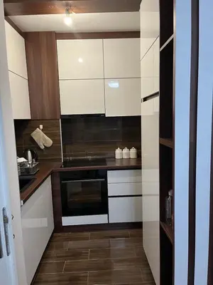 a kitchen with white cabinets and a stove at Saric LuxApartman in Kruševac