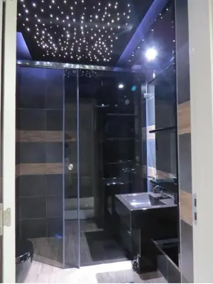 a bathroom with a glass shower and a sink at Harmony in Niš