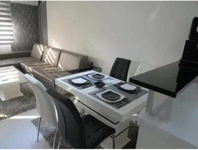 a kitchen with a stove and a table with chairs at Harmony in Niš