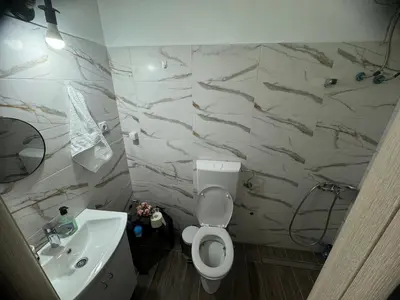 a bathroom with a white toilet and a sink at Sofi IV in Niš