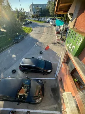 two cars parked on a street next to a building at Sofi IV in Niš