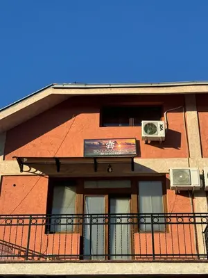 a building with a balcony and a window with a air conditioner at Sofi IV in Niš