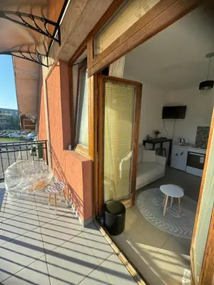 a balcony with a view of a living room at Sofi IV in Niš