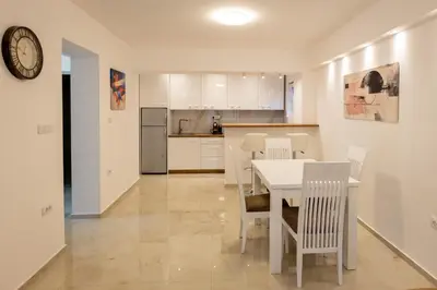 a kitchen and dining room with a table and chairs at Relax in Vranje