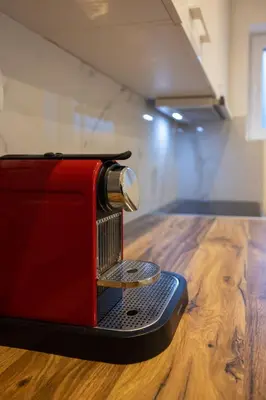 a red toaster sitting on top of a wooden table at Relax in Vranje