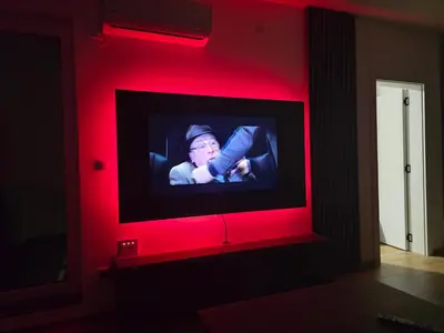 a television with a red light in a room at Sunny lux apartman in Vrnjačka Banja