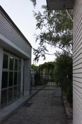 a bench in front of a house with a fence at Vila Lux Milikic in Kraljevo