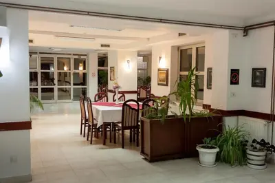 a dining room with a table and chairs at Vila Lux Milikic in Kraljevo