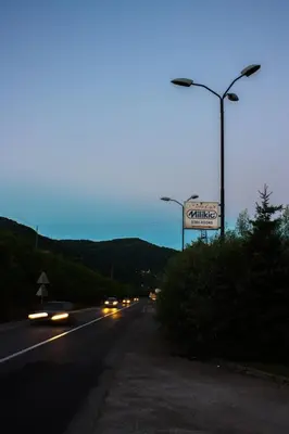 a street with cars driving down the road at night at Vila Lux Milikic in Kraljevo