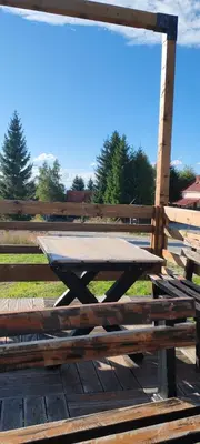 a wooden picnic table sitting next to a wooden fence at Mesečeva bajka in Kopaonik