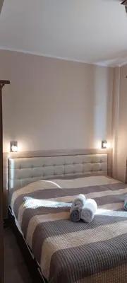 a bedroom with a bed with two towels on it at Mesečeva bajka in Kopaonik