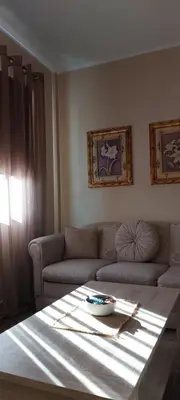 a living room with a table and a couch at Mesečeva bajka in Kopaonik
