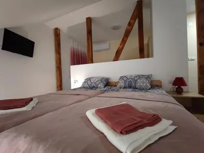a bedroom with a bed with two towels on it at Apartmani Varos & Restaurant in Pirot