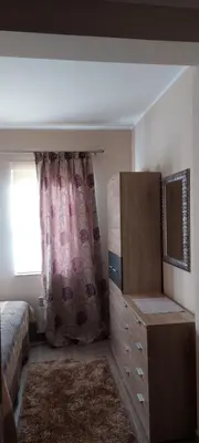 a bedroom with a bed and a dresser and a window at Meseceva bajka 2 in Kopaonik